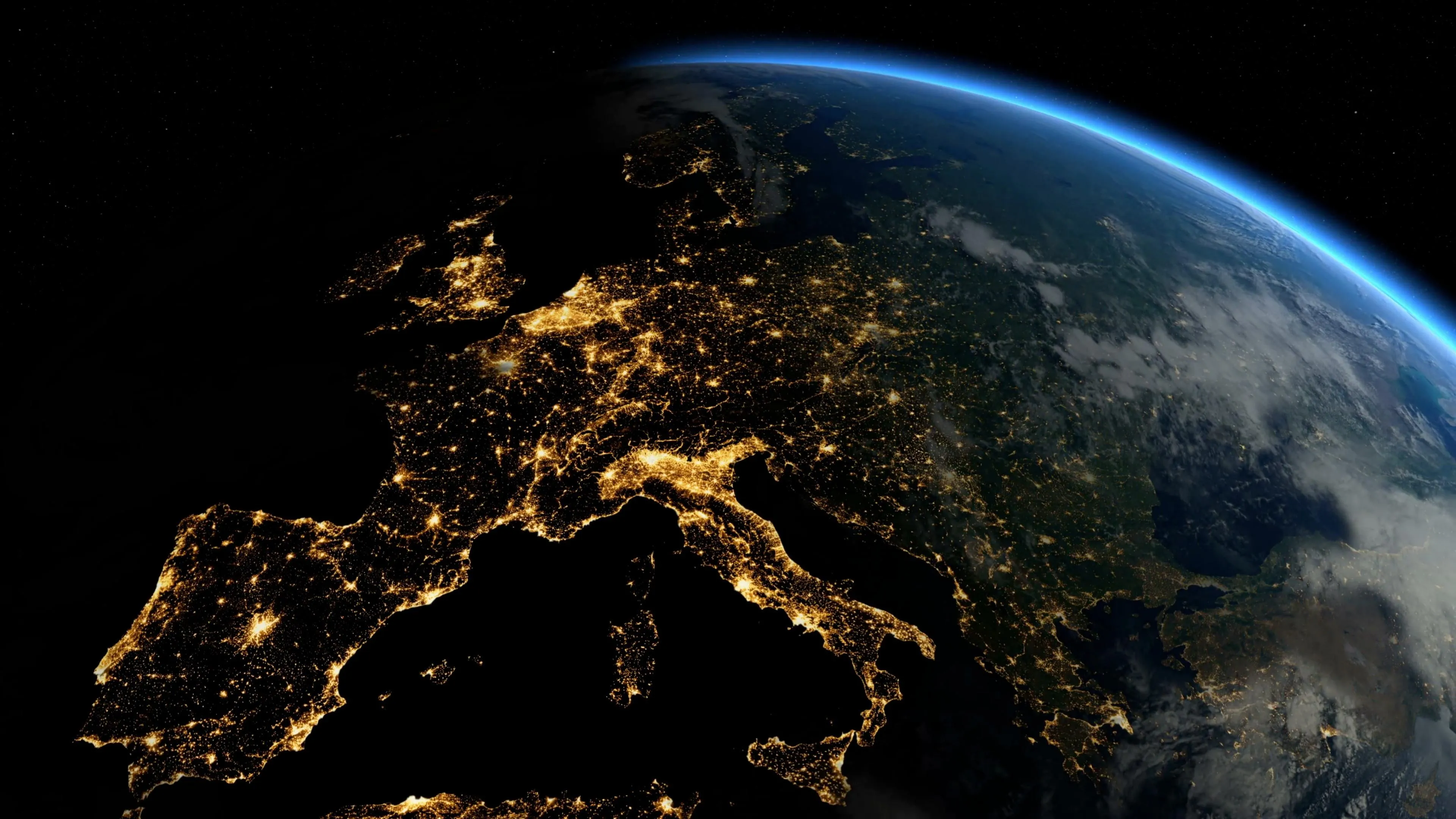 A view of Europe illuminated at night from space, showcasing city lights and geographical features.